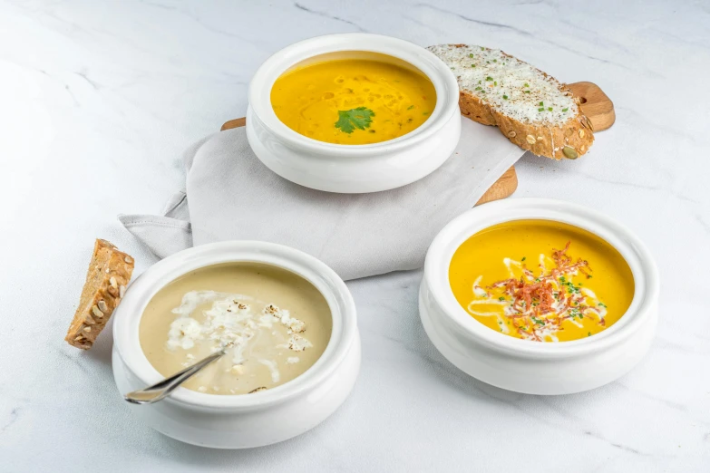 three bowls of soup on a table with bread, a pastel, inspired by Charles Le Roux, dau-al-set, 3 - piece, white, cheeses, various styles