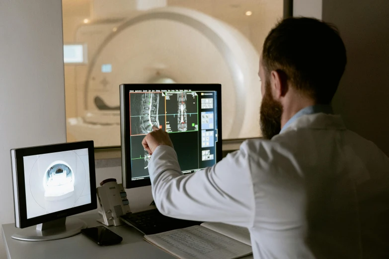 a man sitting at a desk in front of a computer, shutterstock, holography, glowing mri x-ray, 15081959 21121991 01012000 4k, instagram picture, exterior shot