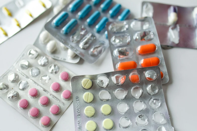 a bunch of contrails sitting on top of a table, by Alison Watt, pexels, plasticien, pills and medicine, palettes, medical labels, on a white table