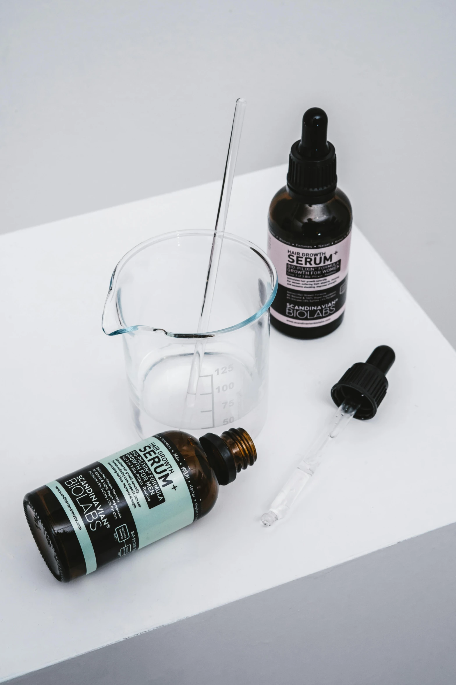 a close up of a bottle of liquid on a table, facial precision, healing tubes, ergodox, collection product