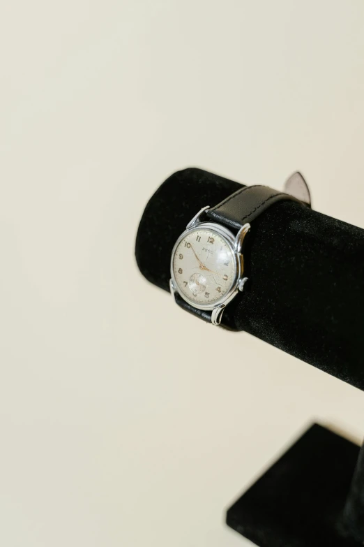 a close up of a watch on a stand, modernism, [ overhead view ]!!, ready to model, thumbnail, 50s