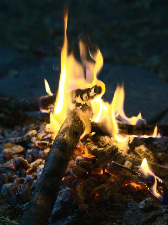 a close up of a fire on a rocky ground, al fresco, profile image, multiple stories, fire staff