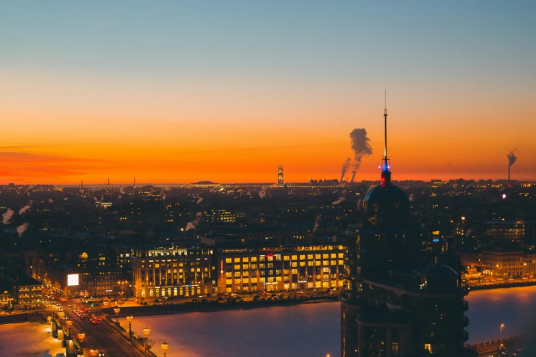 a view of a city from the top of a building, by Sebastian Spreng, pexels contest winner, happening, saint petersburg, cold sunset, burning city background, view from the side