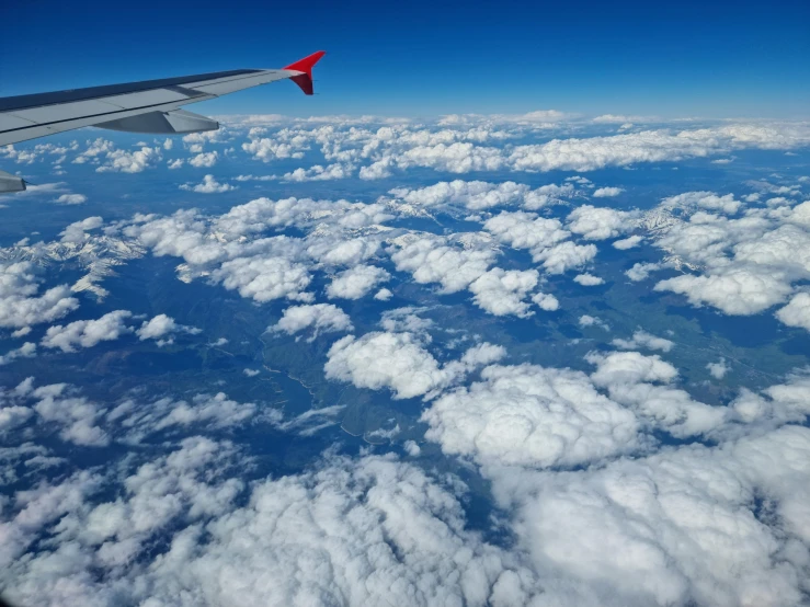 the wing of an airplane flying above the clouds, pexels contest winner, hurufiyya, thumbnail, floating island in the sky, cumulus clouds, high angle view