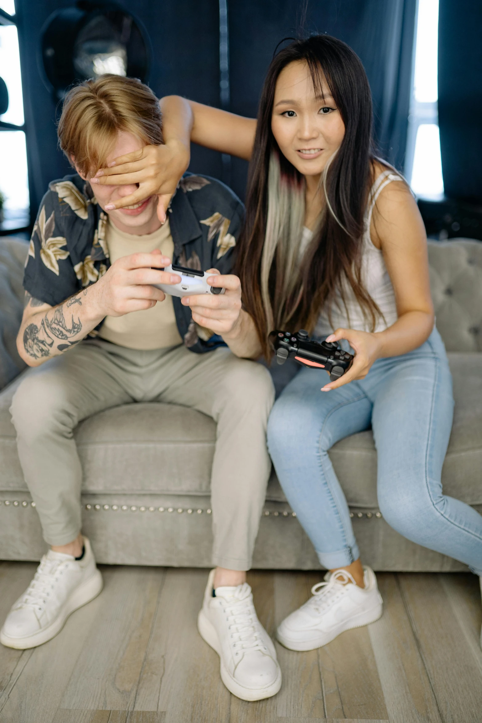 a couple of people that are sitting on a couch, trending on pexels, realism, playing games, half asian, low quality photo, youtube thumbnail