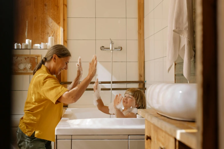 a woman washing a child in a bathtub, pexels contest winner, waving arms, cottagecore, high quality image, thumbnail