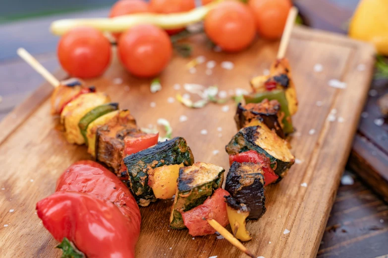 a wooden cutting board topped with skewers of food, by Niko Henrichon, unsplash, renaissance, square, ratatouille style, avatar image