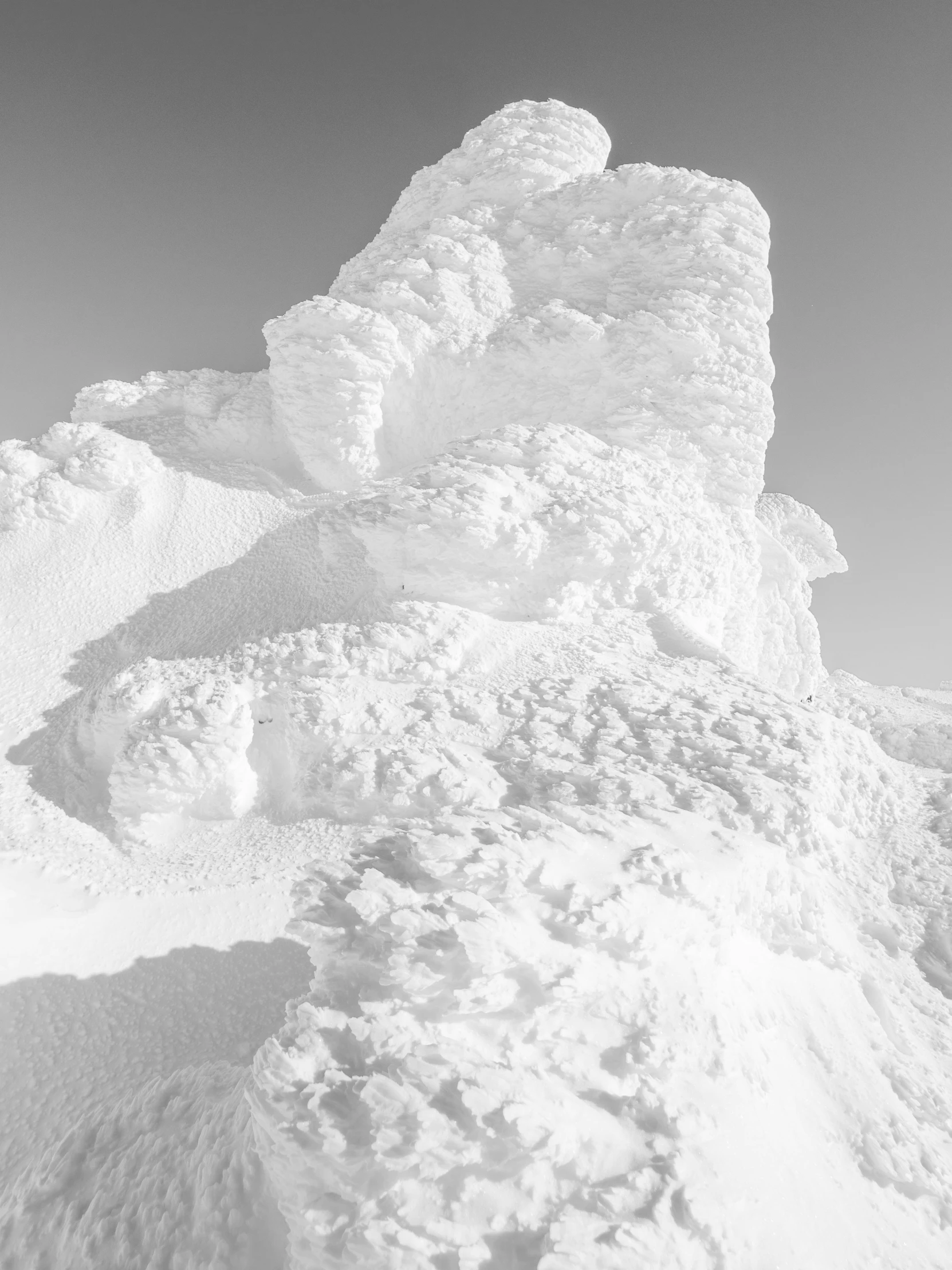 a man riding a snowboard down the side of a snow covered slope, an ambient occlusion render, by Andrei Kolkoutine, bernd and hilla becher, an ice volcano, stacked image, michal mraz