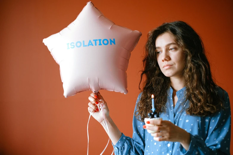 a woman holding a balloon with the word isolation on it, an album cover, pexels, celebration, inflatable, holding wand, product introduction photo