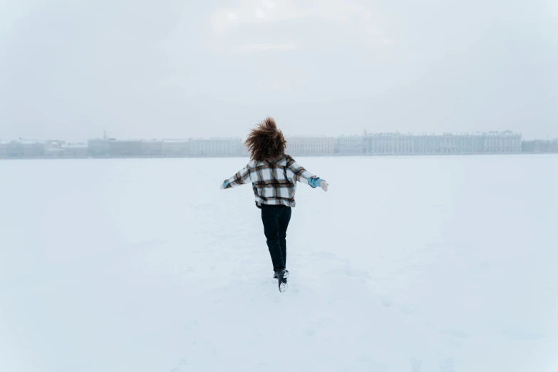 a woman walking across a snow covered field, by Lucia Peka, pexels contest winner, saint petersburg, white backround, all overly excited, half turned around