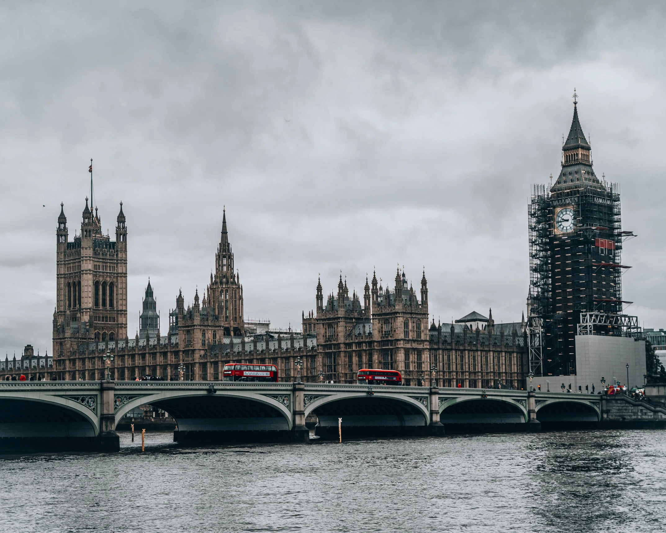 the big ben clock tower towering over the city of london, pexels contest winner, brutalism, all buildings on bridge, gray skies, gif, building along a river