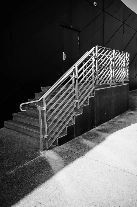 a black and white photo of a set of stairs, [ metal ], in chippendale sydney, epic. 1 0 0 mm, stainless steal