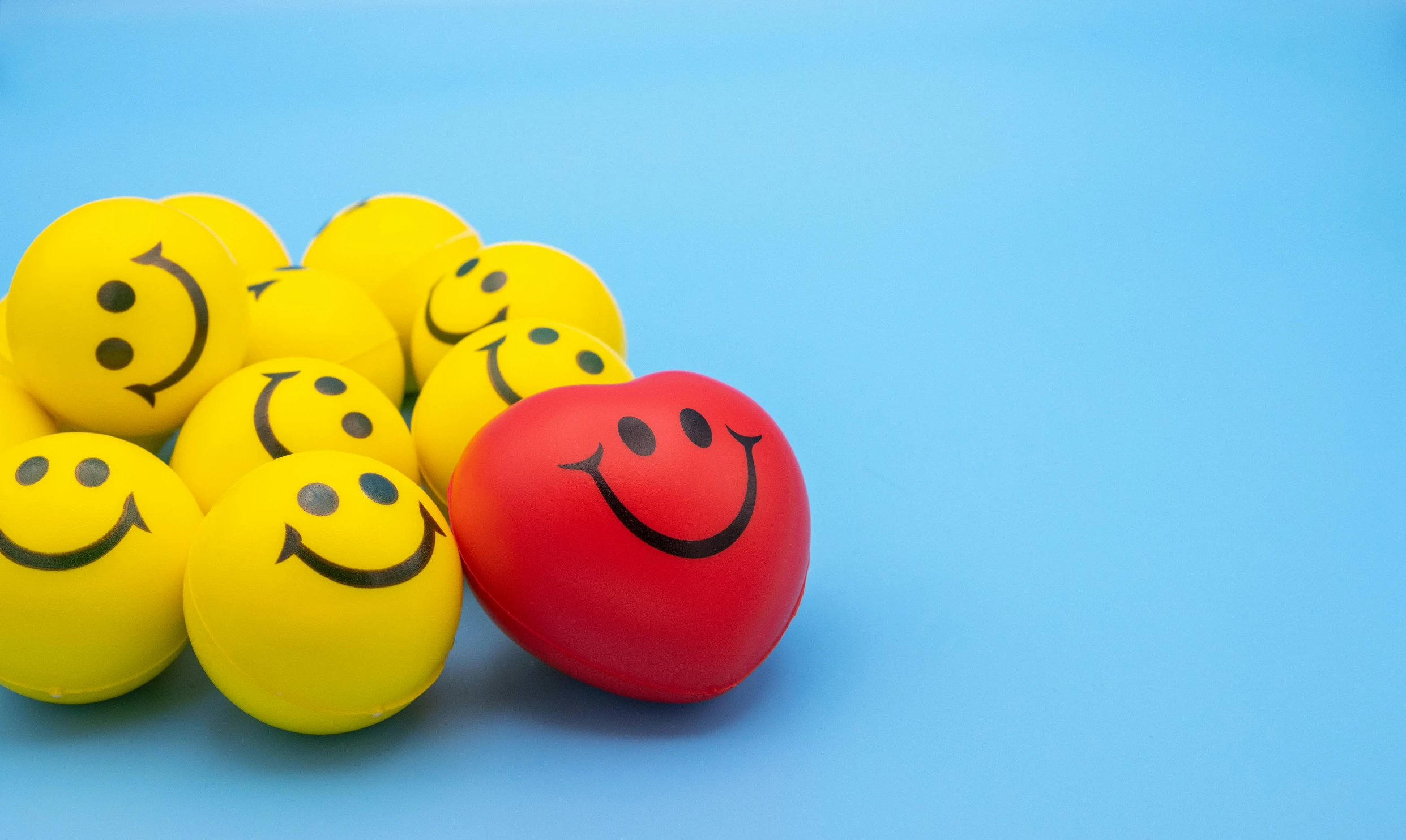 a bunch of yellow balls with smiley faces on them, scarlet and yellow scheme, relaxed. blue background, taken with sony alpha 9, thumbnail