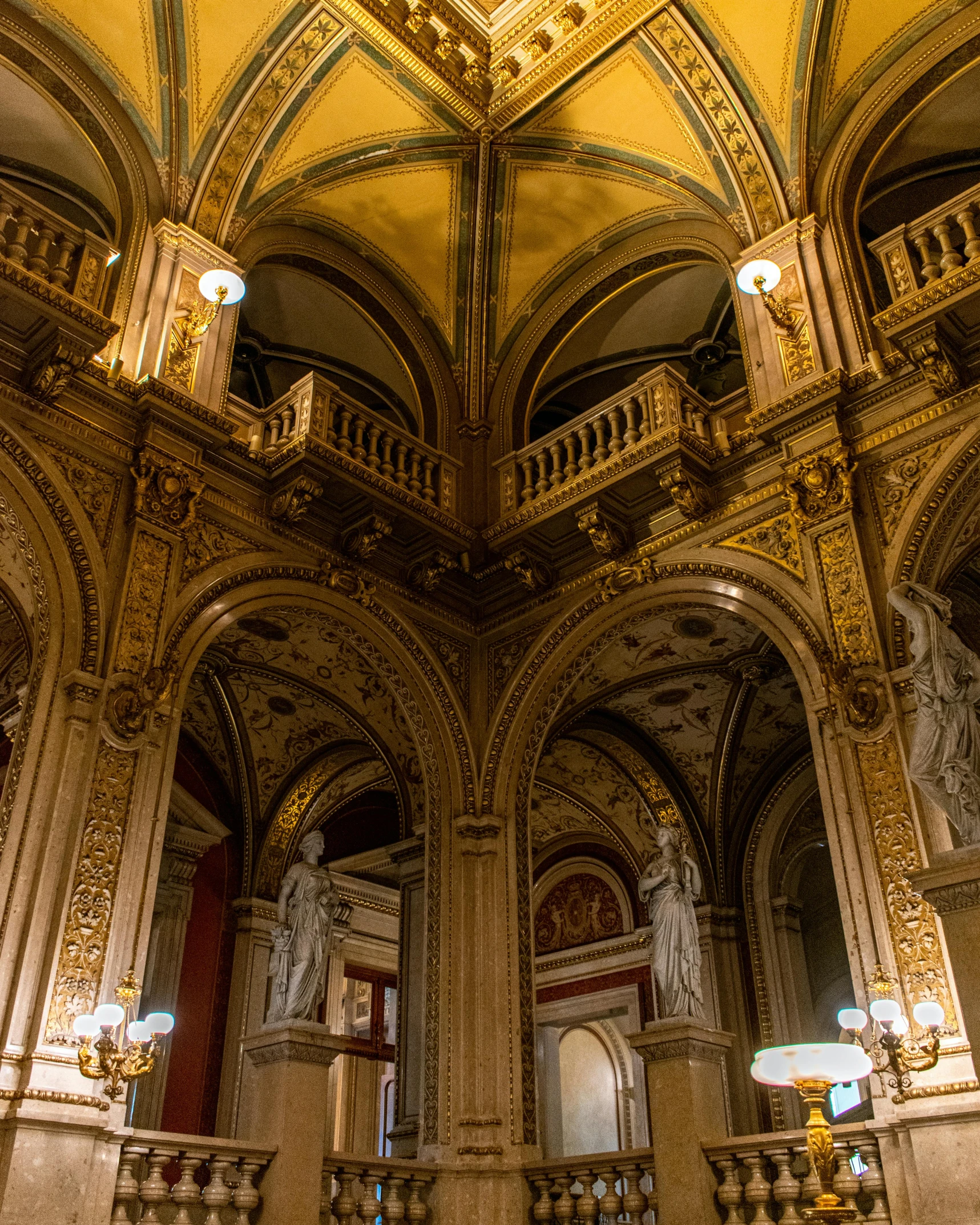 a couple of people that are standing in a building, inspired by Mihály Munkácsy, pexels contest winner, rococo, vienna state opera house, thumbnail, tall arches, lower and upper levels