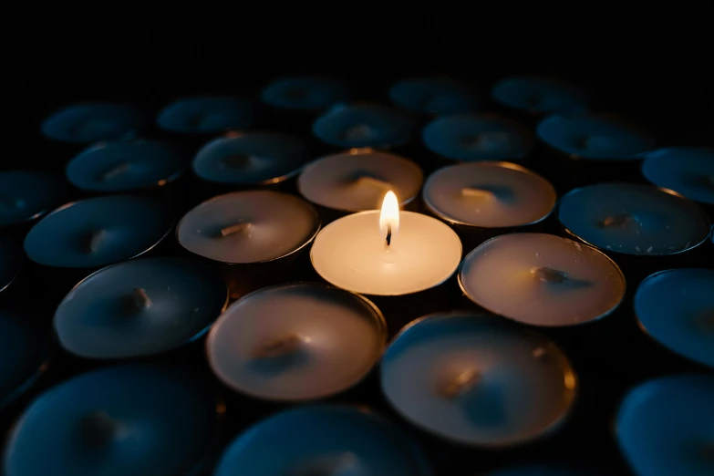 a close up of a lit candle in a bowl of water, inspired by Elsa Bleda, trending on unsplash, visual art, in a room full of candles, profile image, fan favorite, mourning