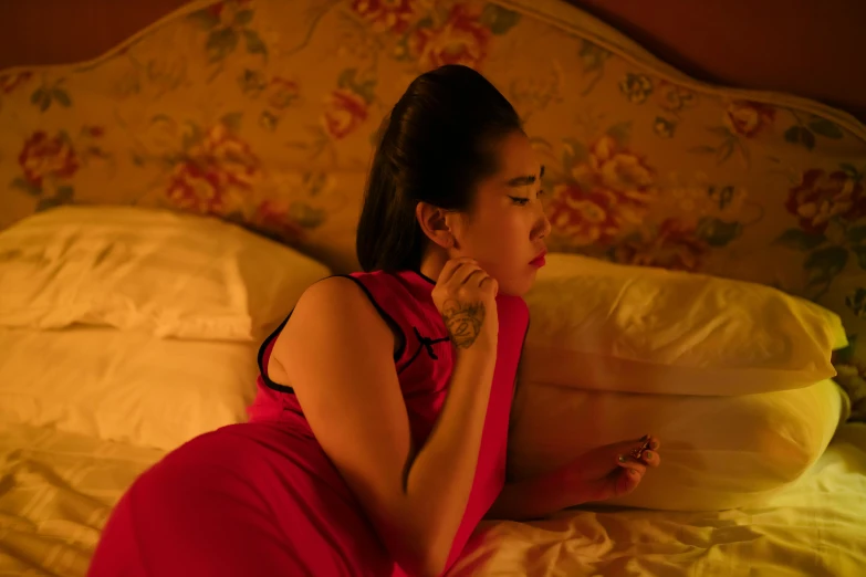 a woman in a red dress sitting on a bed, inspired by Nan Goldin, pexels, digital art, 8 0 s asian neon movie still, traditional chinese, scene from the film, evening