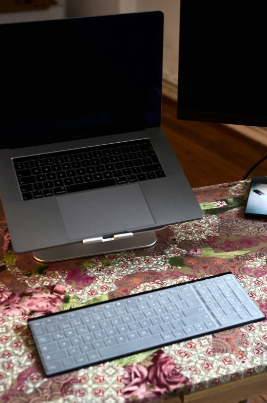 a laptop computer sitting on top of a wooden desk, by Carey Morris, battle stand, grey, - 6, square