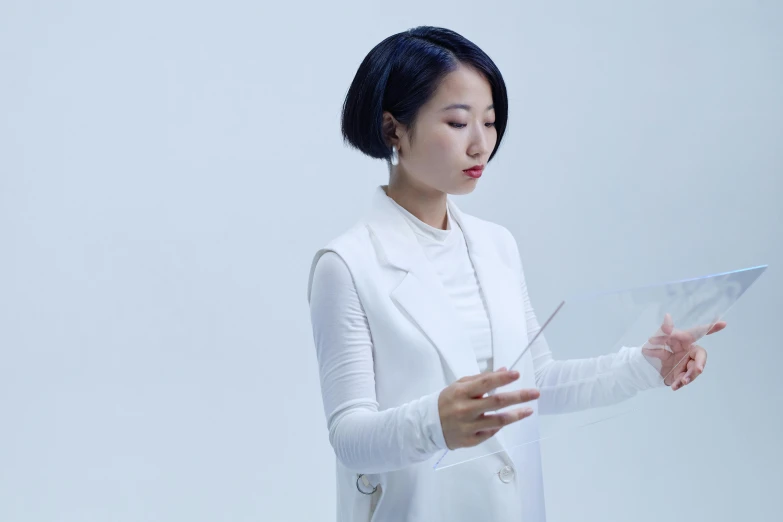 a woman in a white dress holding a piece of paper, inspired by Fei Danxu, analytical art, with short hair, electronics see through, still frame, promotional image