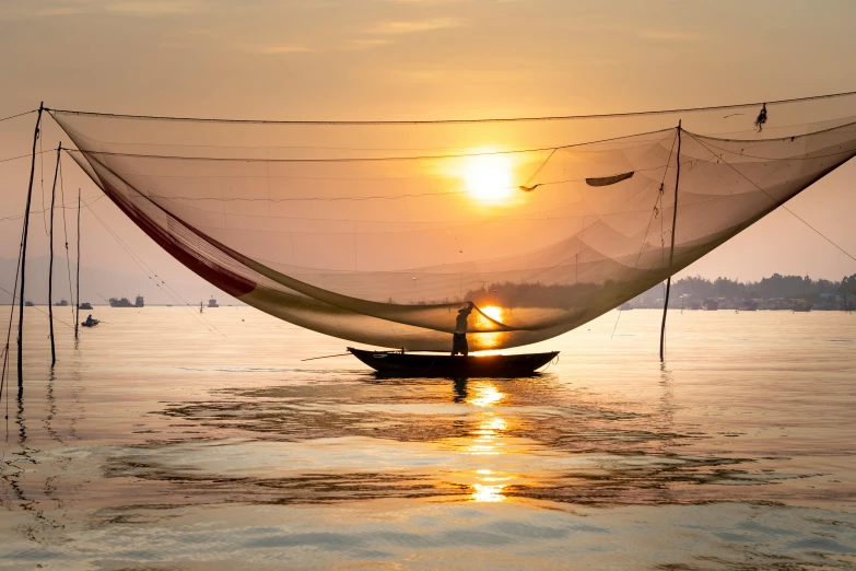 a boat that is sitting in the water, inspired by Steve McCurry, pexels contest winner, netting, asian sun, waking up, hoang lap