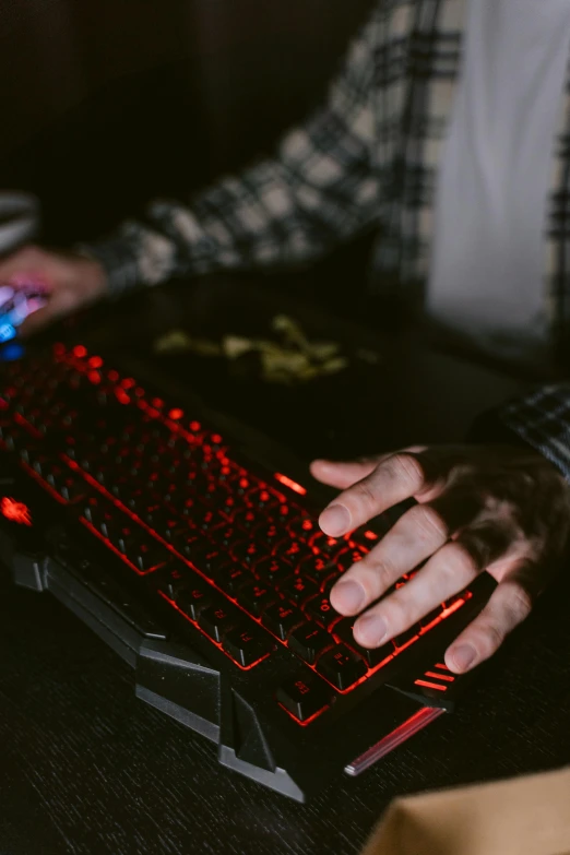 a close up of a person typing on a keyboard, by Everett Warner, pexels, red leds, lawther sit at table playing dnd, /r/razer, mid body shot