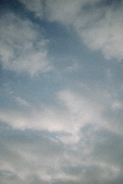 a person flying a kite on a cloudy day, a picture, by Linda Sutton, postminimalism, “puffy cloudscape, looking up to the sky, close - up photograph, color photograph