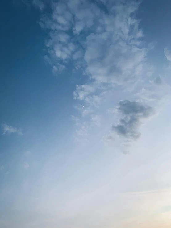 a man flying a kite on top of a sandy beach, unsplash, minimalism, face made out of clouds, rinko kawauchi, low quality photo, sky blue