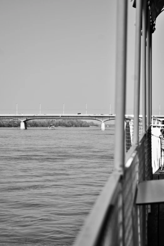 a black and white photo of a bridge over a body of water, by Dave Melvin, on a boat, red river, f / 2 0, monorail