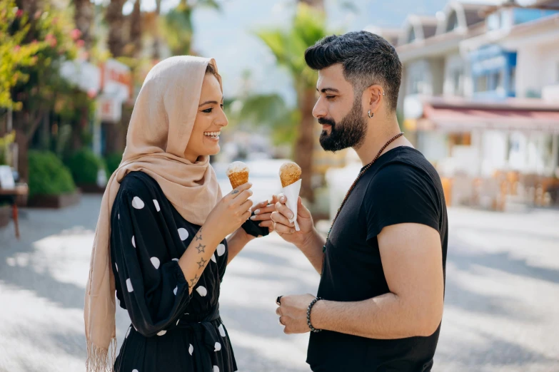 a man and woman standing next to each other eating donuts, pexels contest winner, hurufiyya, ice cream cone, young middle eastern woman, a handsome, bosnian