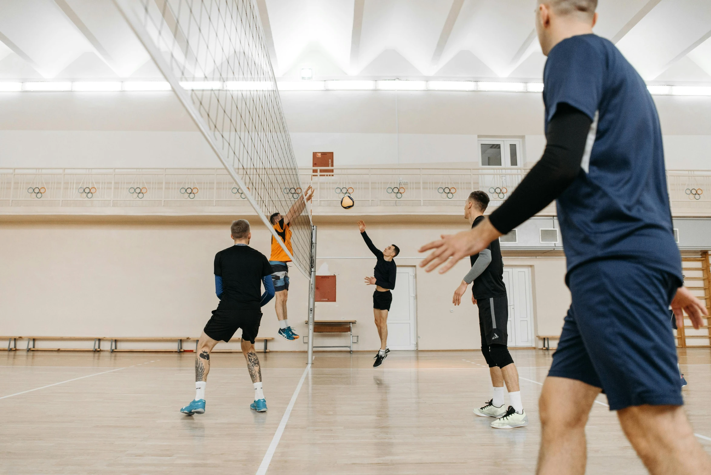 a group of men playing a game of volleyball, pexels contest winner, arabesque, tall ceilings, profile image, male and female, thumbnail