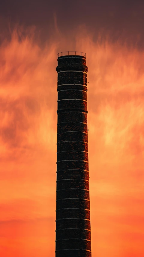 a tall tower sitting on top of a lush green field, by Carey Morris, unsplash contest winner, ventilation shafts, sunset lighting 8k, paisley, made of lava