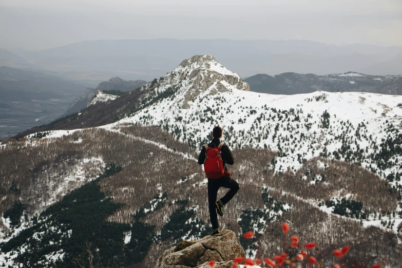 a man standing on top of a snow covered mountain, by Emma Andijewska, unsplash contest winner, red roses at the top, hiking in rocky mountain, avatar image, slovakia