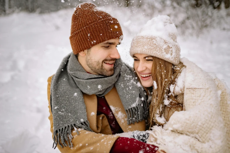 a man and a woman standing in the snow, pexels contest winner, beanie, avatar image, romantic period, brown