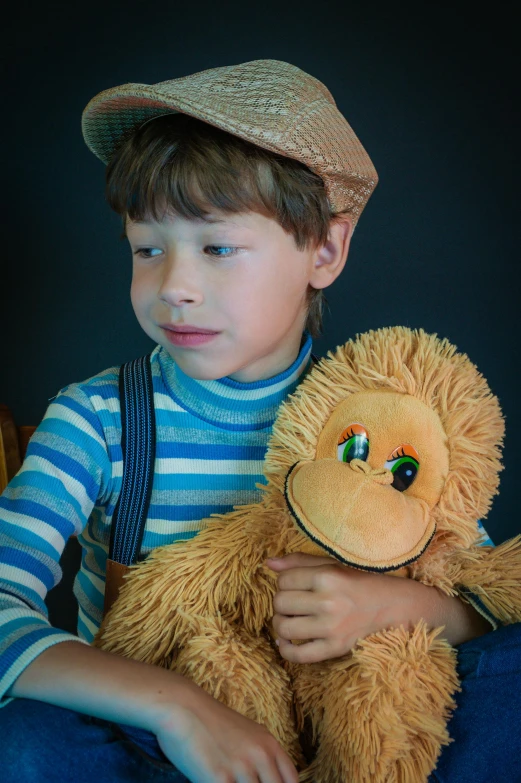 a young boy sitting on a chair holding a teddy bear, inspired by George Barker, pexels, visual art, caracter with brown hat, puppet, frown fashion model, slide show