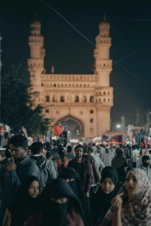 a crowd of people walking down a street at night, provocative indian, mosque, portrait featured on unsplash, color footage