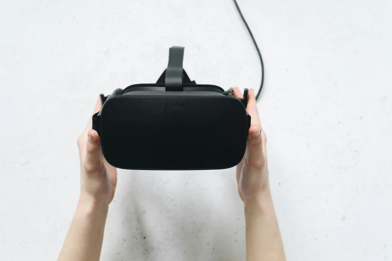 a person holding a virtual reality device in their hands, a computer rendering, by Carey Morris, unsplash, trending on dezeen, rectangle, black, oculus rift