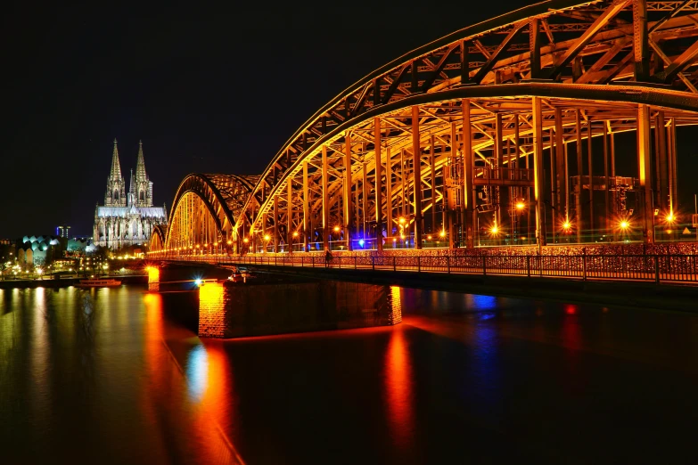 a bridge over a body of water at night, by Thomas Häfner, pexels contest winner, art nouveau, chrome cathedrals, brown, 15081959 21121991 01012000 4k, german renaissance architecture