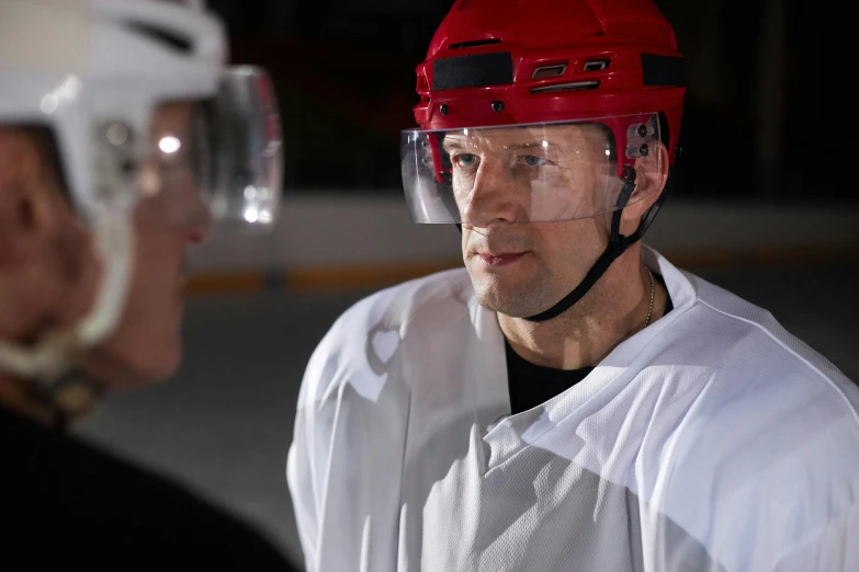 a couple of men standing next to each other wearing helmets, nhl, eye level shot, scientific, sport glasses