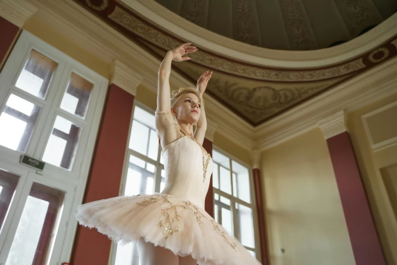 a woman that is standing in a room, by Elizabeth Polunin, shutterstock, arabesque, wearing a tutu, palace, white, full frame image