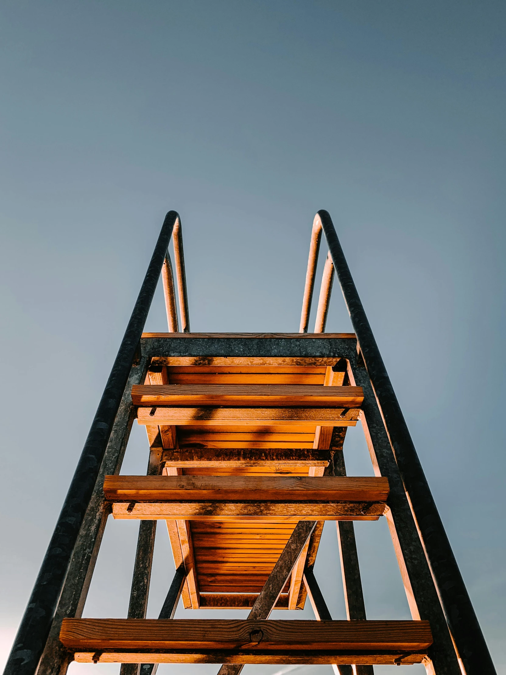 a wooden staircase going up into the sky, by Niko Henrichon, trending on unsplash, orange and blue sky, detail structure, gallows, high quality photo