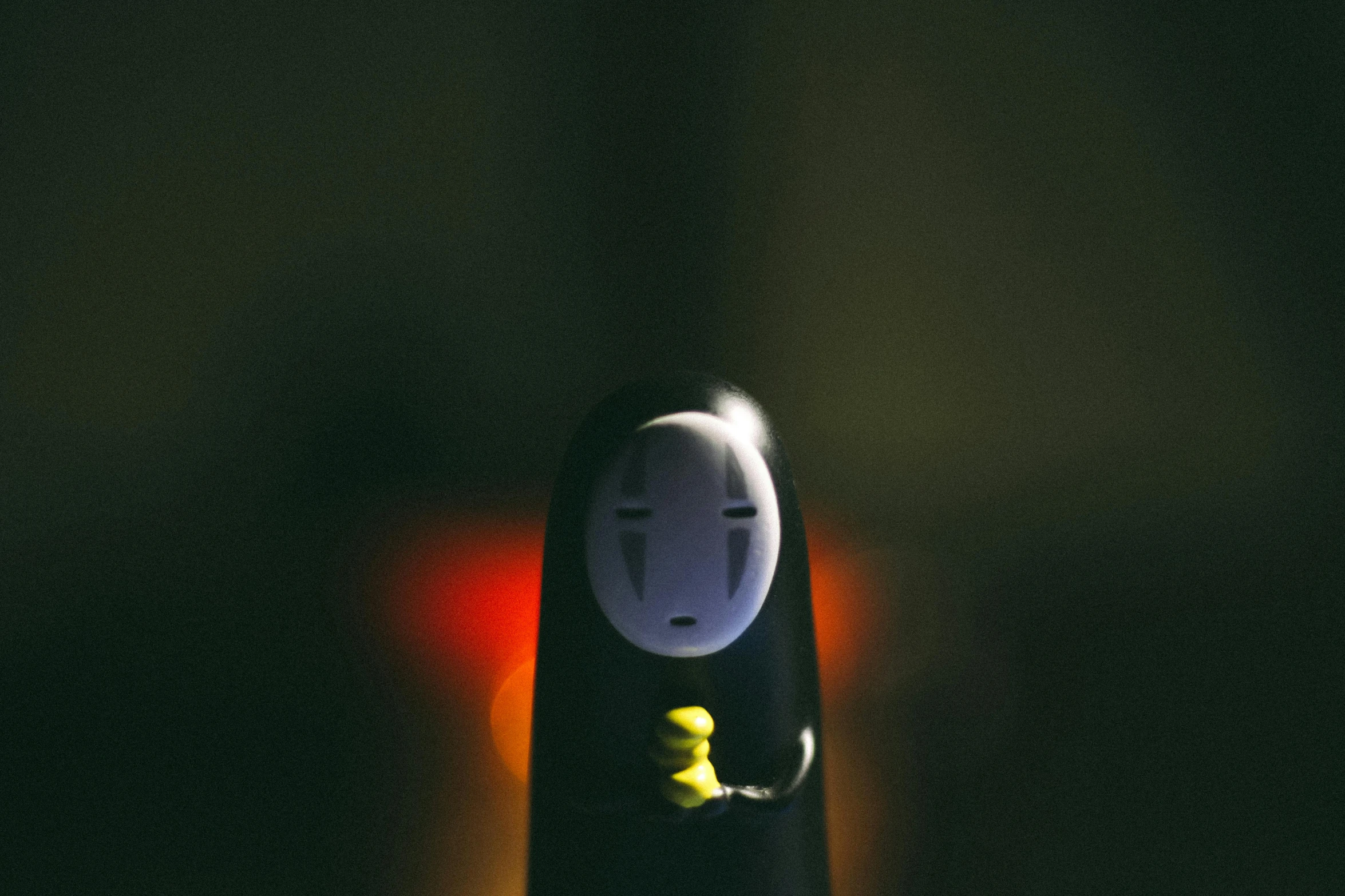 a close up of a person holding a cell phone, inspired by Nara Yoshitomo, unsplash, minimalism, with glowing yellow eyes, spirited away, toy photo, emerging from the darkness