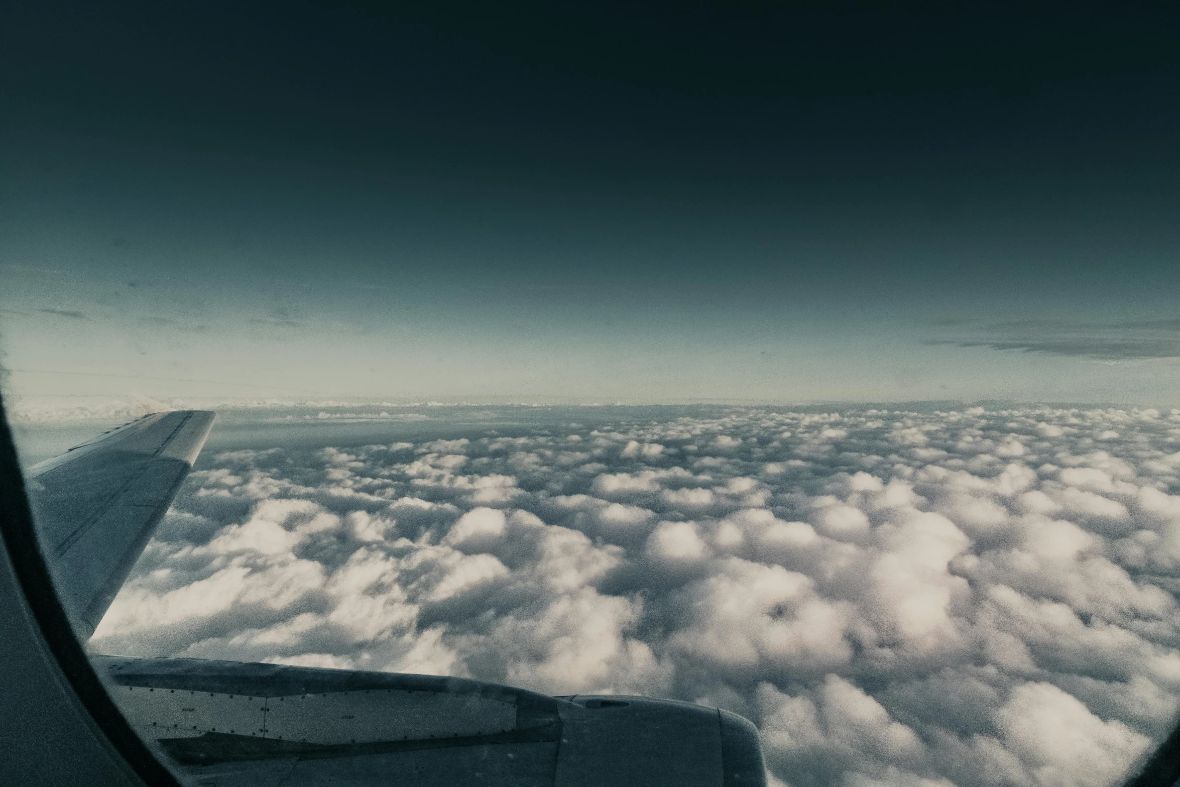 a view of clouds from an airplane window, by Adam Marczyński, pexels contest winner, surrealism, cockpit view, plain uniform sky, cinematic footage, gray clouds
