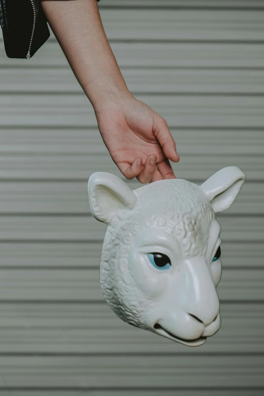 a close up of a person holding a sheep mask, inspired by Jeff Koons, unsplash, 3 d print, exterior shot, frontal shot, large