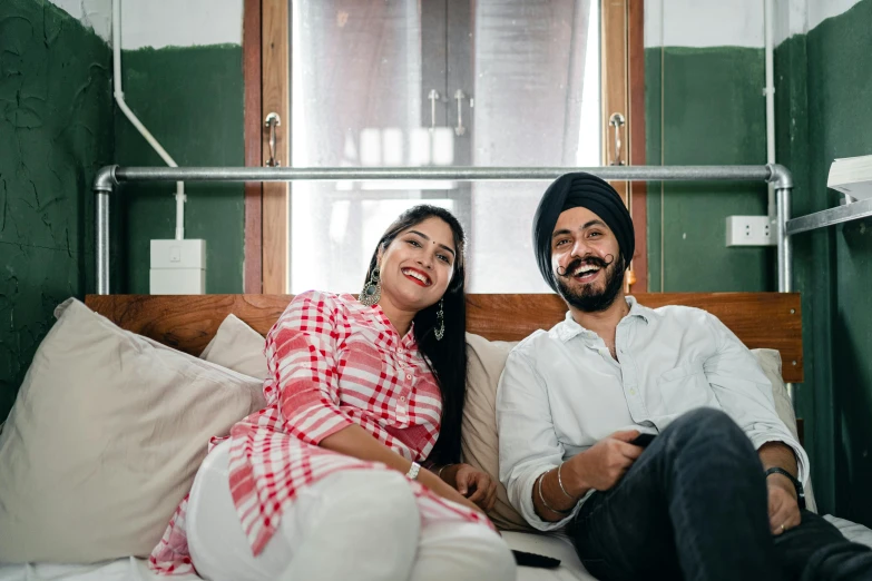 a man and a woman sitting on a bed, a portrait, inspired by Manjit Bawa, pexels contest winner, relaxing on the couch, proud looking, blank, promotional image