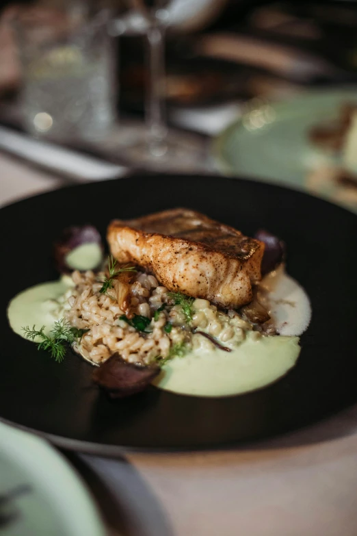 a close up of a plate of food on a table, by Matt Cavotta, seafoam green, fish tail, raphael lecoste, square