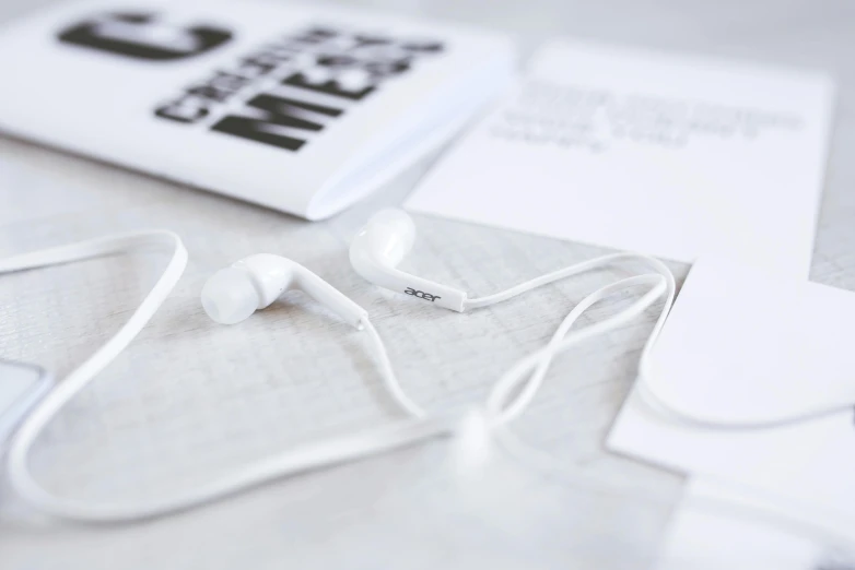 a pair of headphones sitting on top of a table, an album cover, inspired by Cerith Wyn Evans, unsplash, all white, miniature product photo, white details, angle view