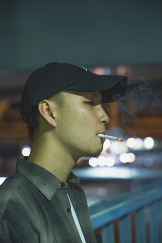 a man standing on a bridge smoking a cigarette, inspired by Liam Wong, unsplash, hyperrealism, set in tokyo bank parking lot, wearing a backwards baseball cap, with a pointed chin, taken in the late 2010s