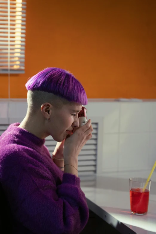 a woman with purple hair sitting at a table, trending on pexels, brown buzzcut, heartbroken, milk bar magazine, vibrant scene