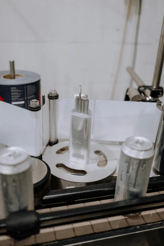 a stove top with pots and pans on it, by Jakob Gauermann, unsplash, bauhaus, pathology sample test tubes, in a factory, made out of shiny white metal, bottle of vodka