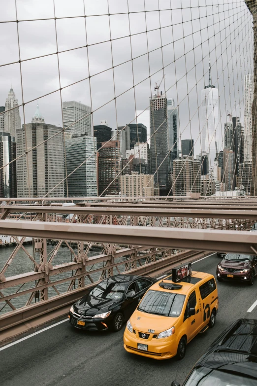 a street filled with lots of traffic next to tall buildings, inspired by Thomas Struth, pexels contest winner, lots of bridges, brooklyn, taxis, bridge