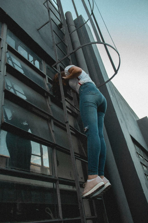 a woman climbing up the side of a tall building, inspired by Elsa Bleda, pexels contest winner, leggings, exiting store, mechanics, gif